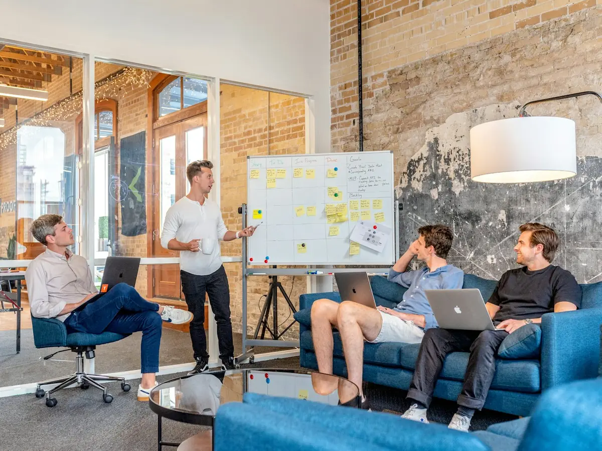 Team collaborating around a whiteboard in a workshop